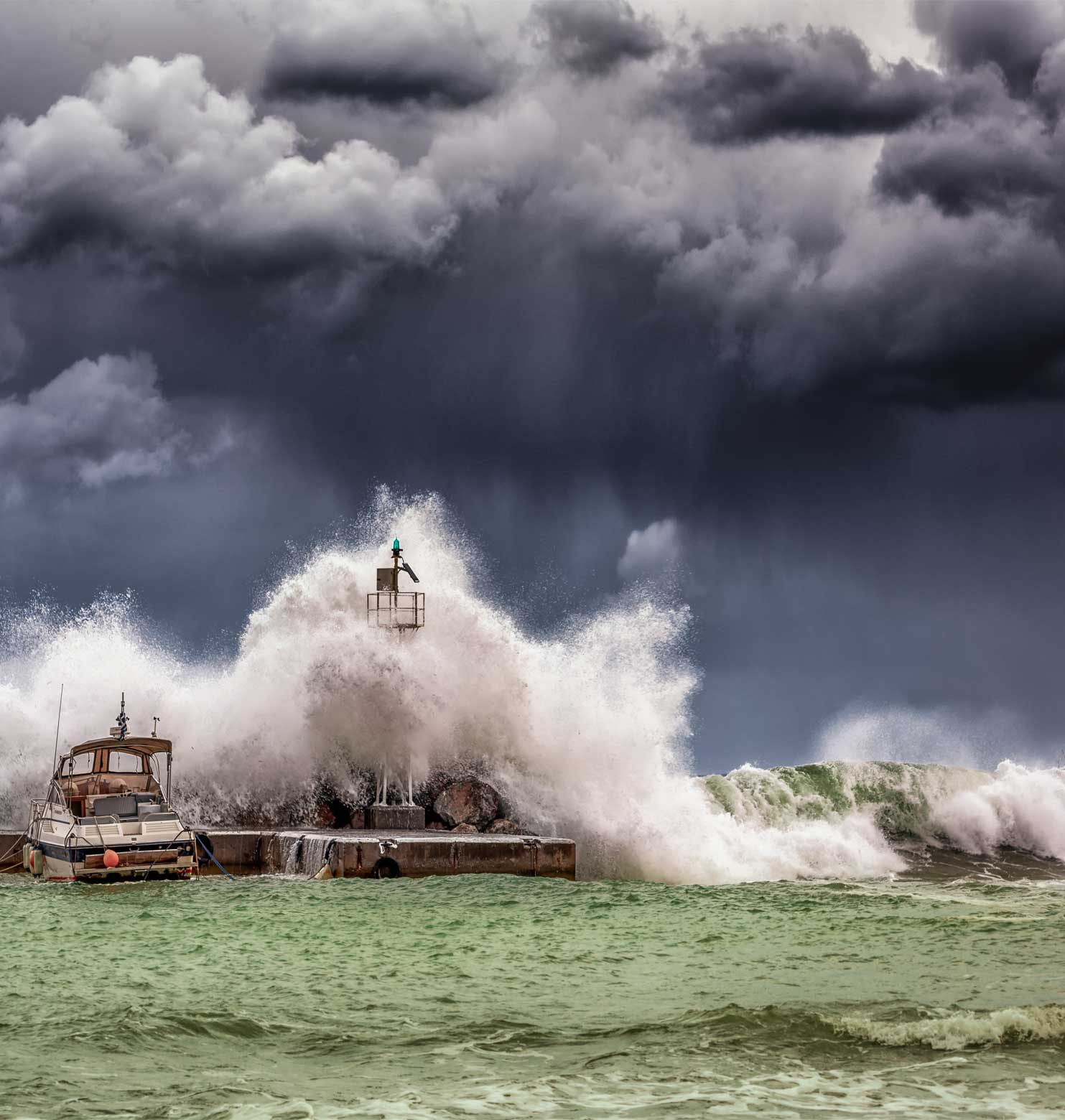 ocean waves splashing on breakwater