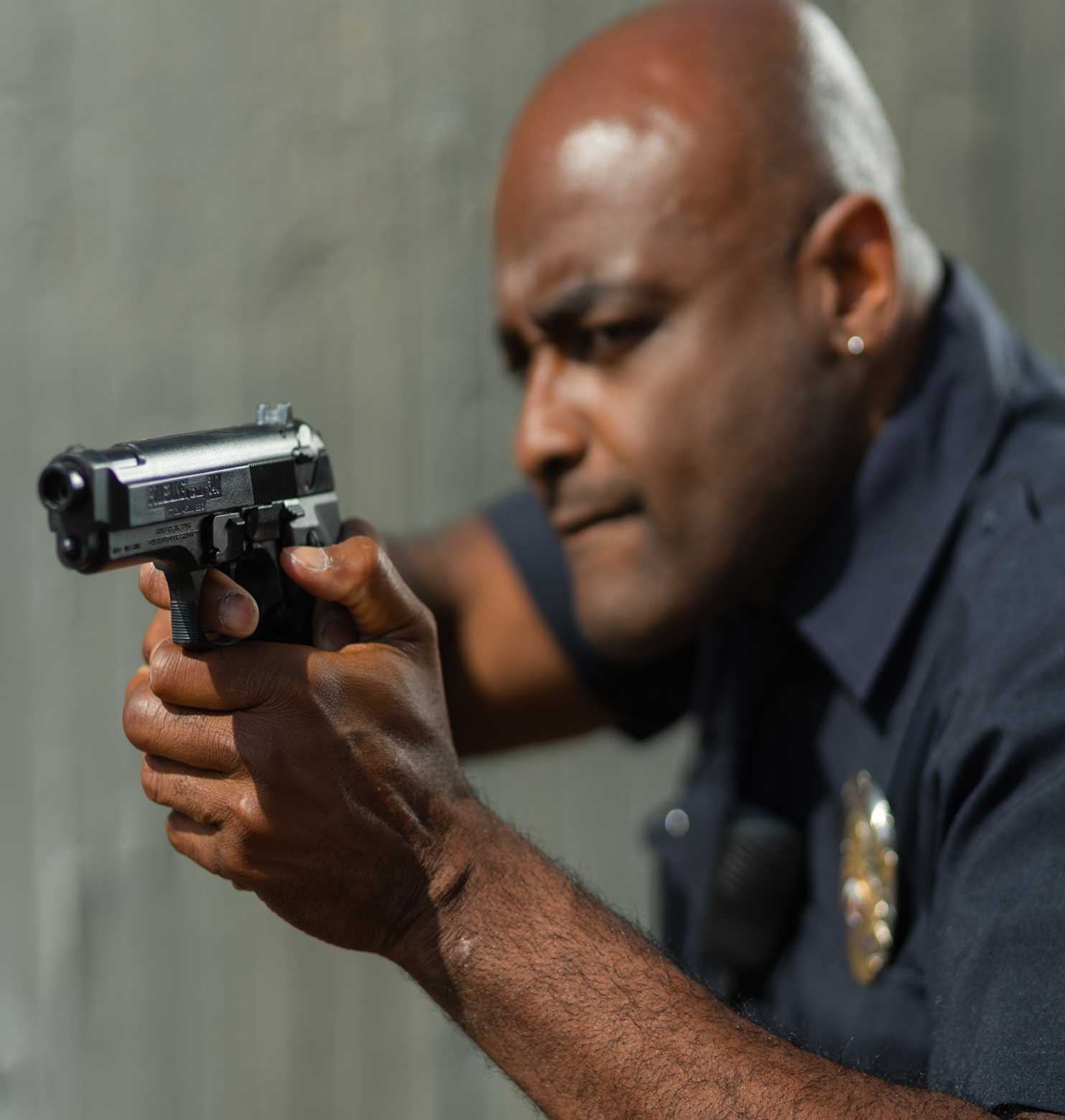 police officer with gun drawn